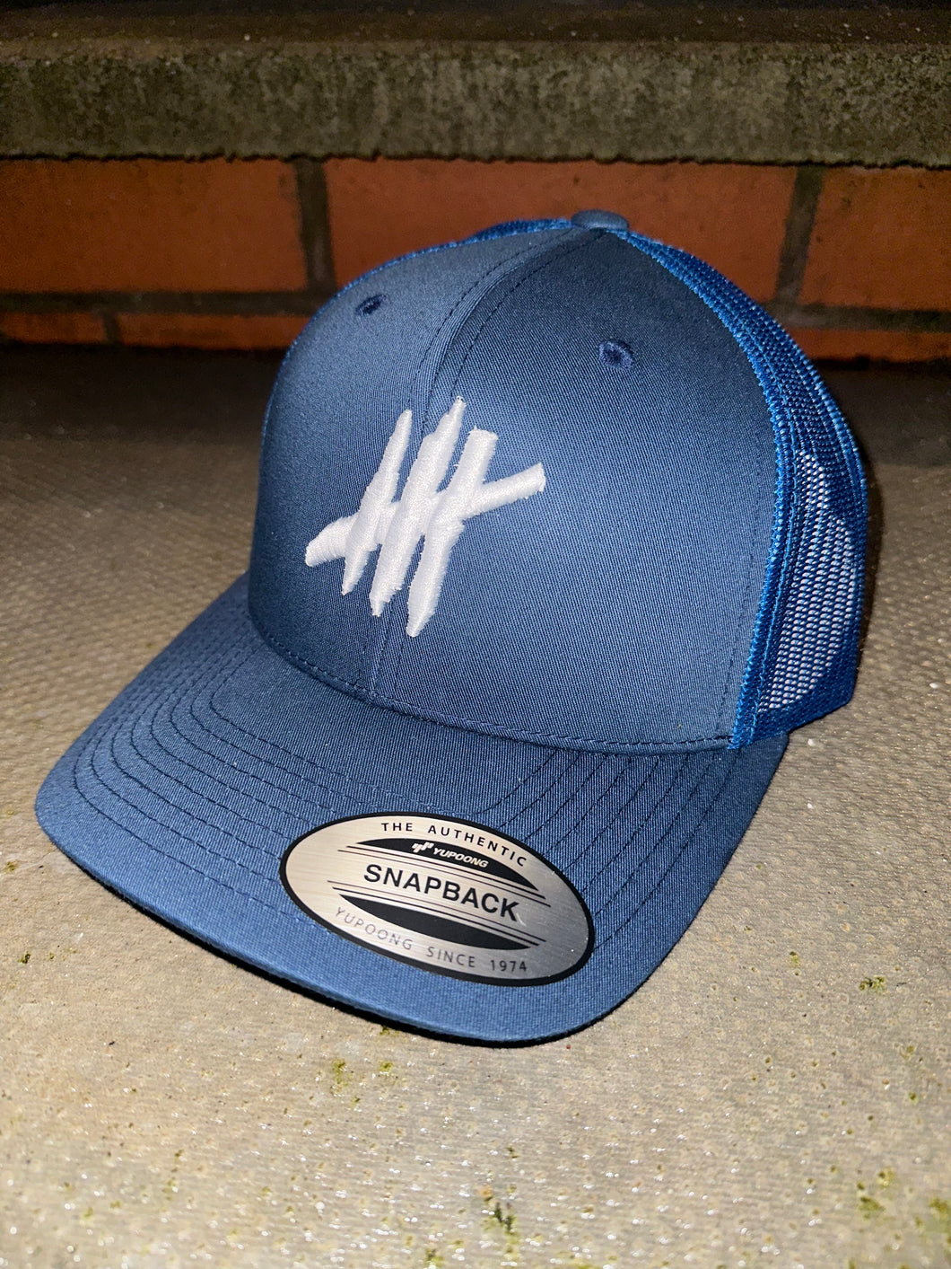 Navy & blue trucker cap with white logo