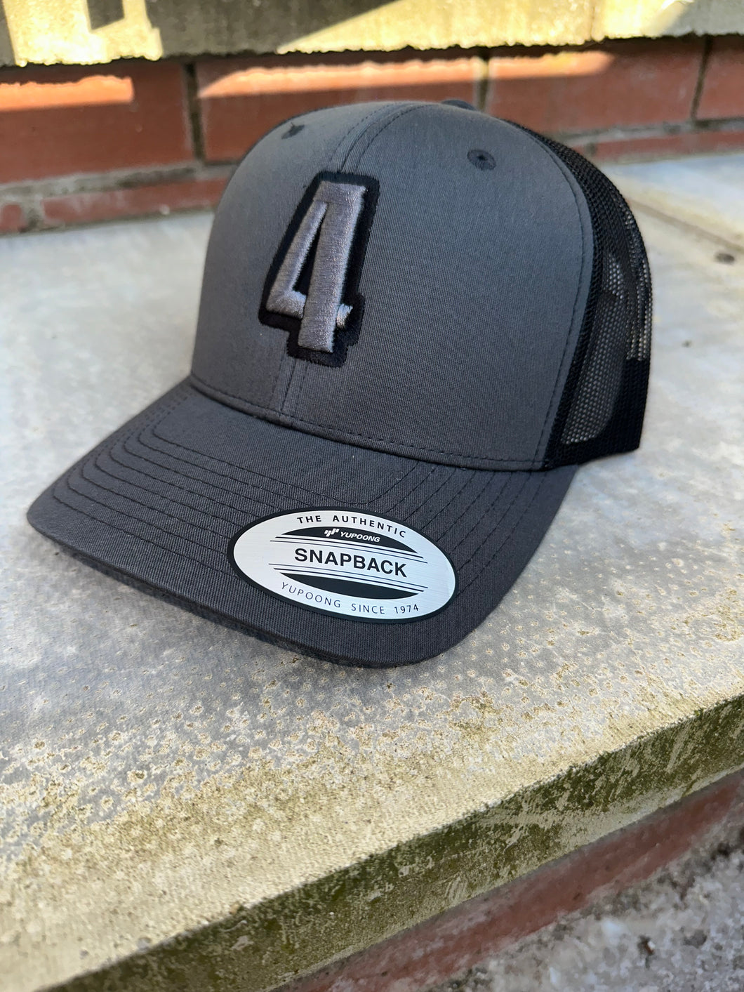 Grey & black trucker cap with grey & black logo