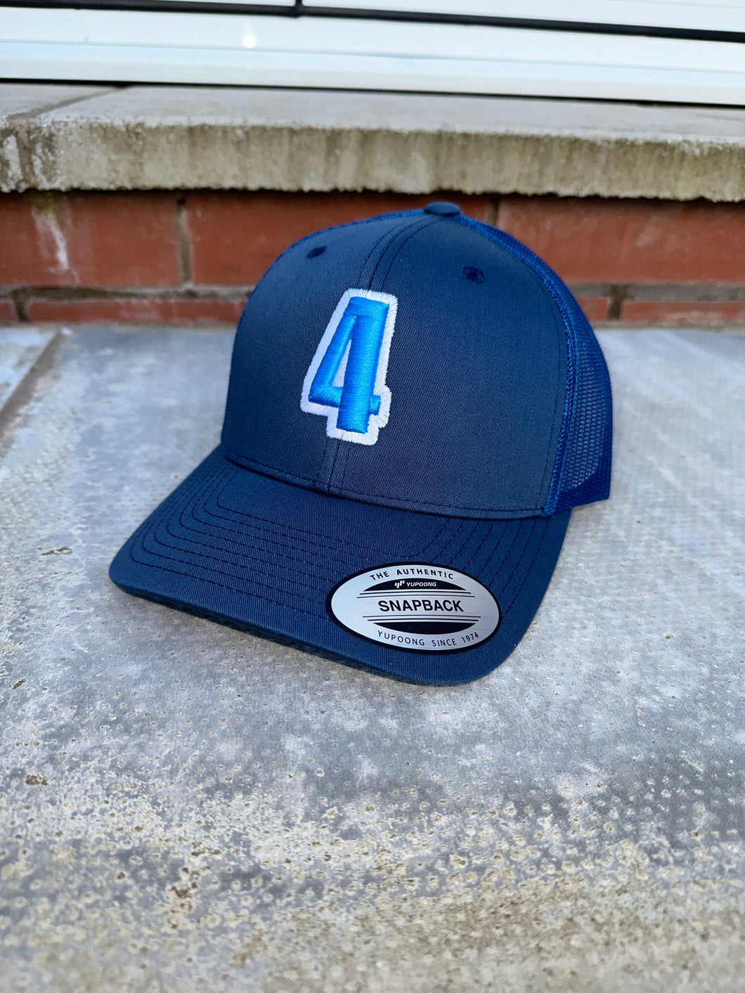 Navy & blue trucker cap with light blue & white logo