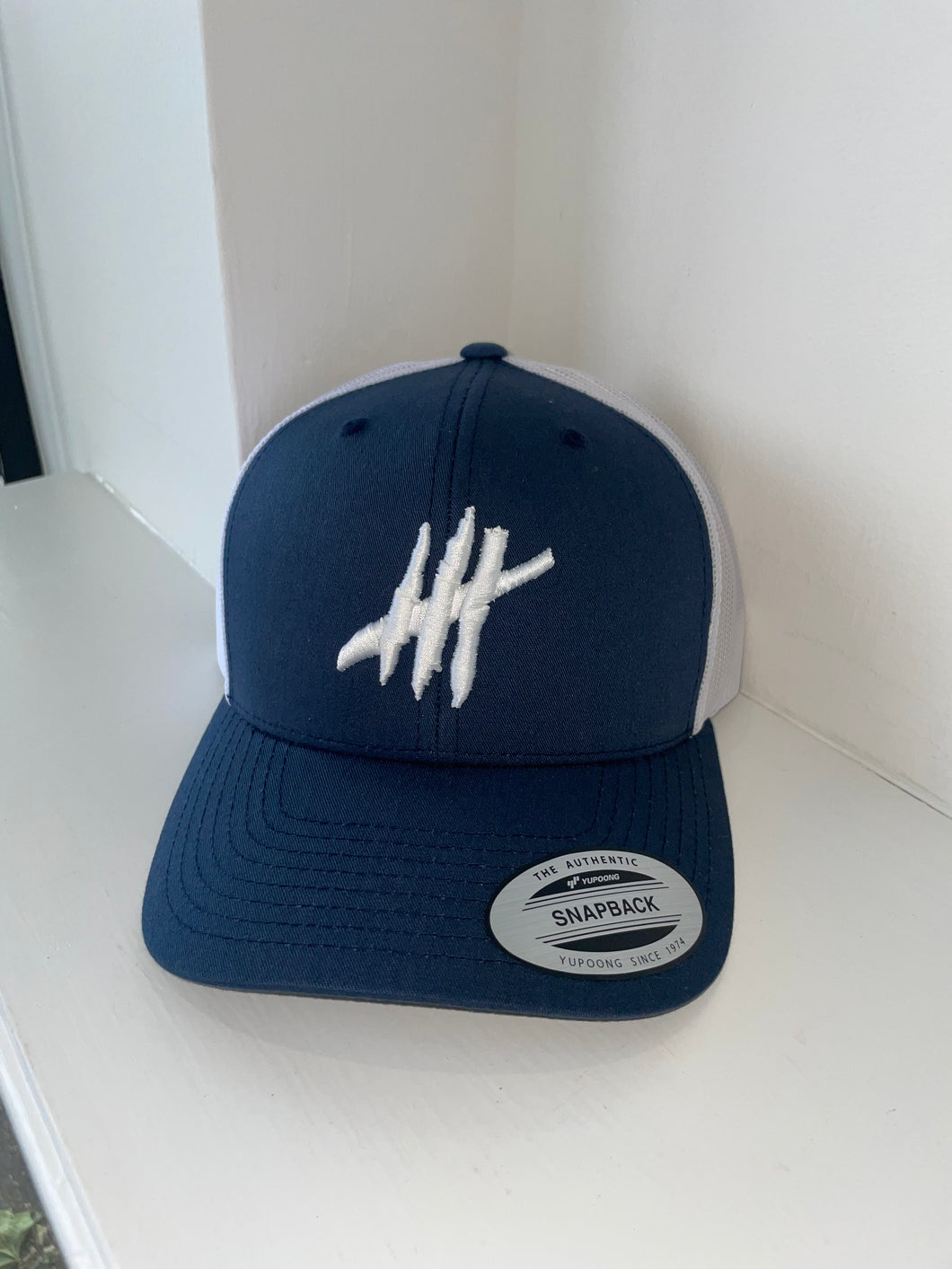Navy & white trucker cap with white logo