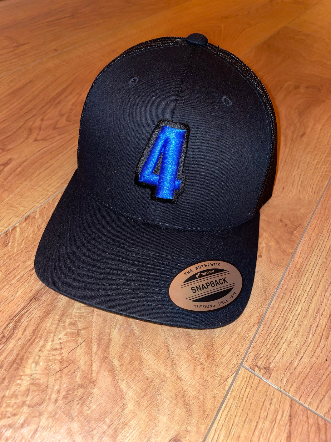 Black Trucker Cap With Blue Logo