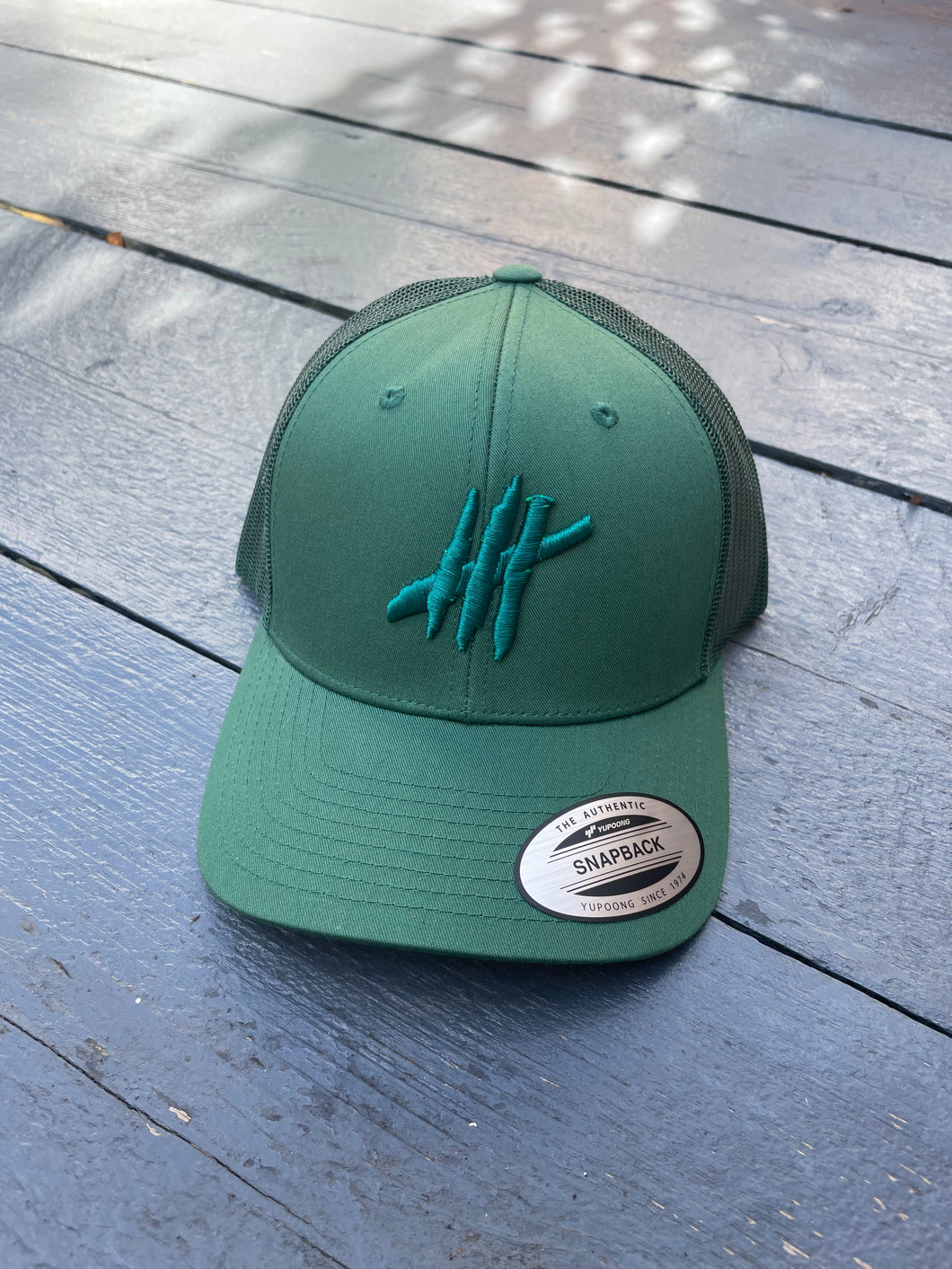 Green trucker cap with green logo
